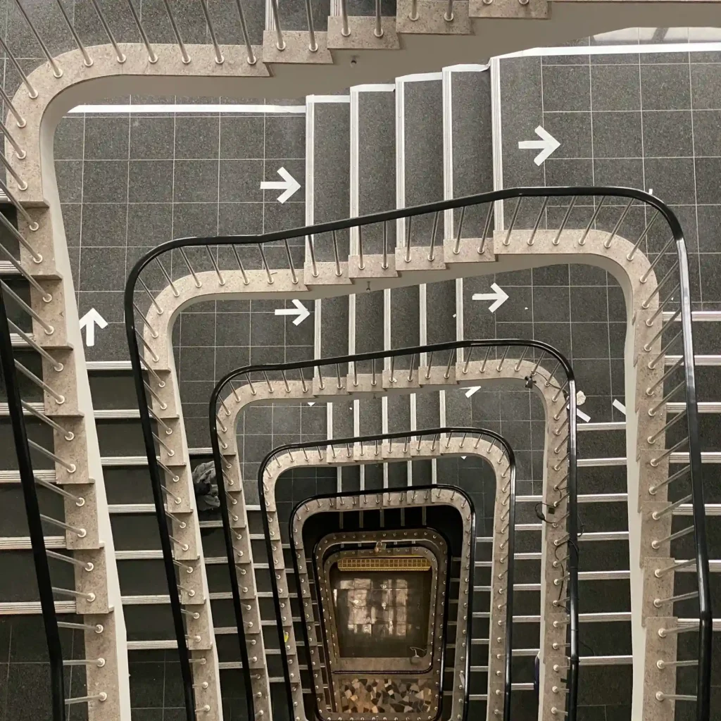 The staircase leading to the next level symbolizes career growth and achieving new heights.