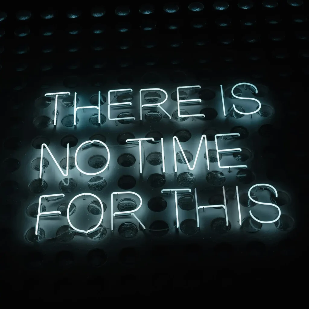 Neon sign: 'THERE IS NO TIME FOR THIS', illustrating the importance of time management.