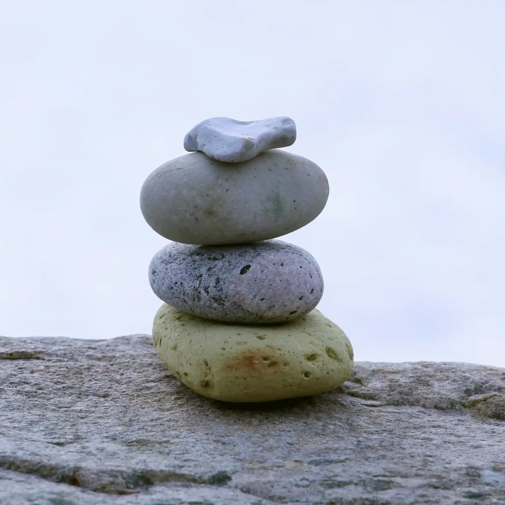 Zen stones are stacked in harmony, symbolizing balance and stability.