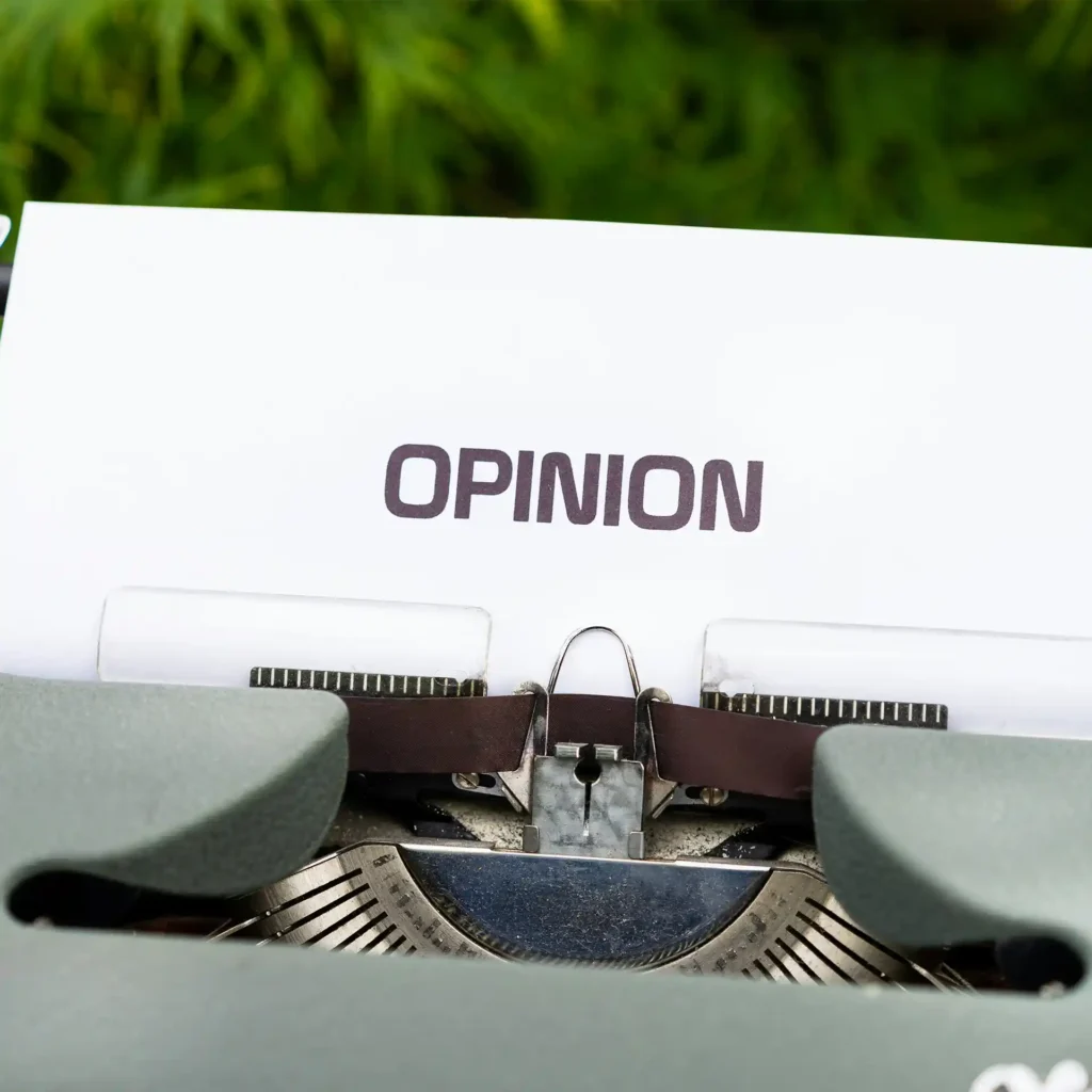Typewriter with the word 'OPINION', symbolizing the author's personal thoughts and views.
